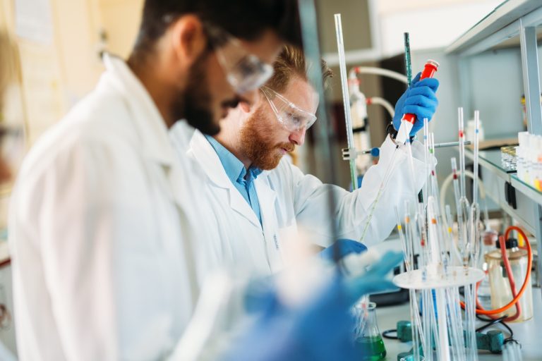 Young students of chemistry working in laboratory